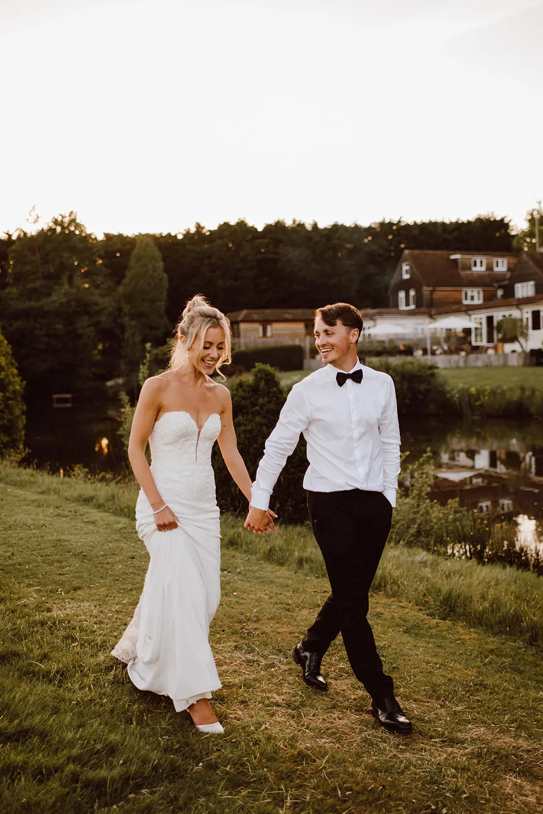 bride and groom by lake Brookfield Barn