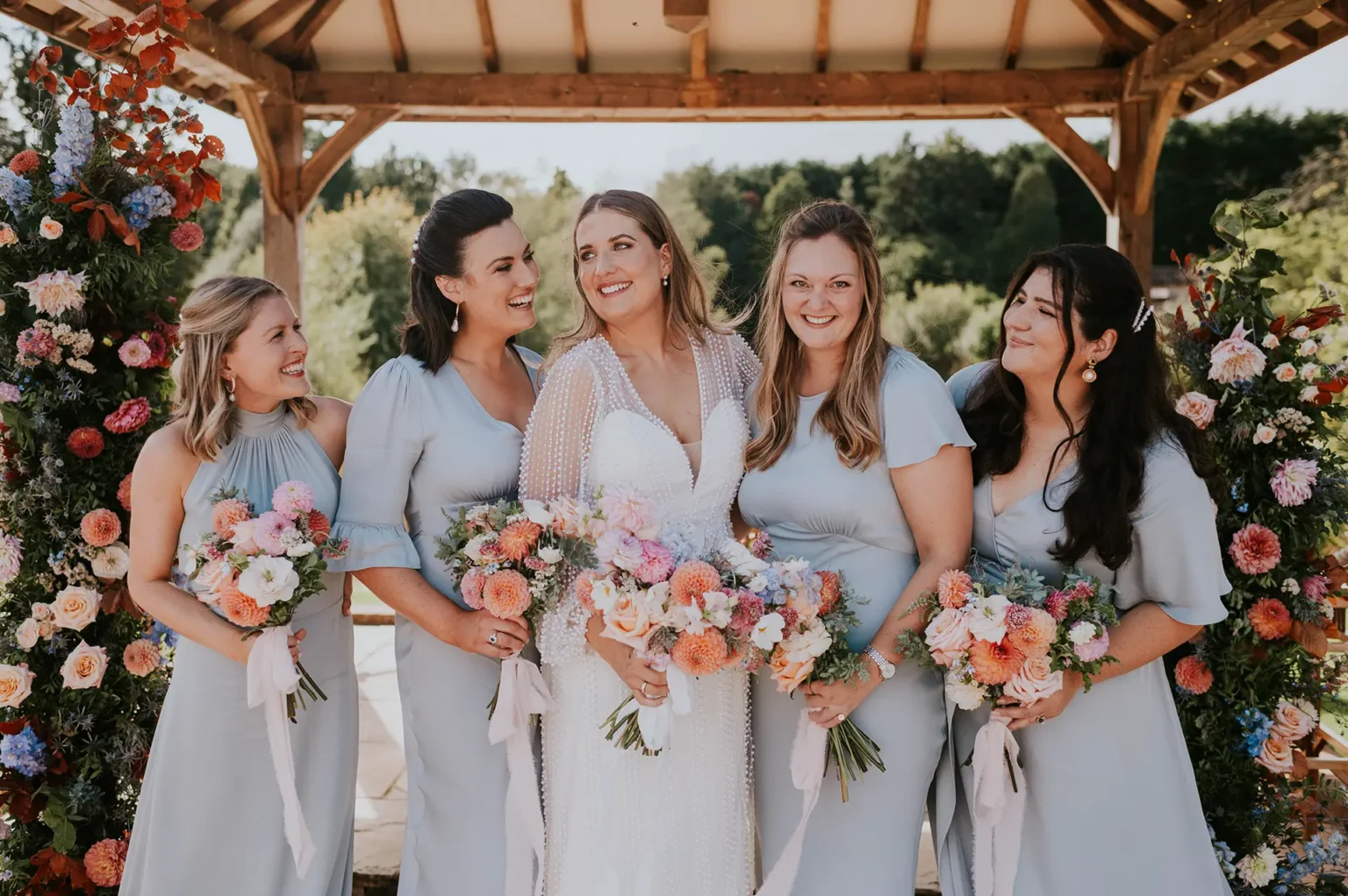 Brookfield Barn bride bridesmaids with colourful wedding flowers