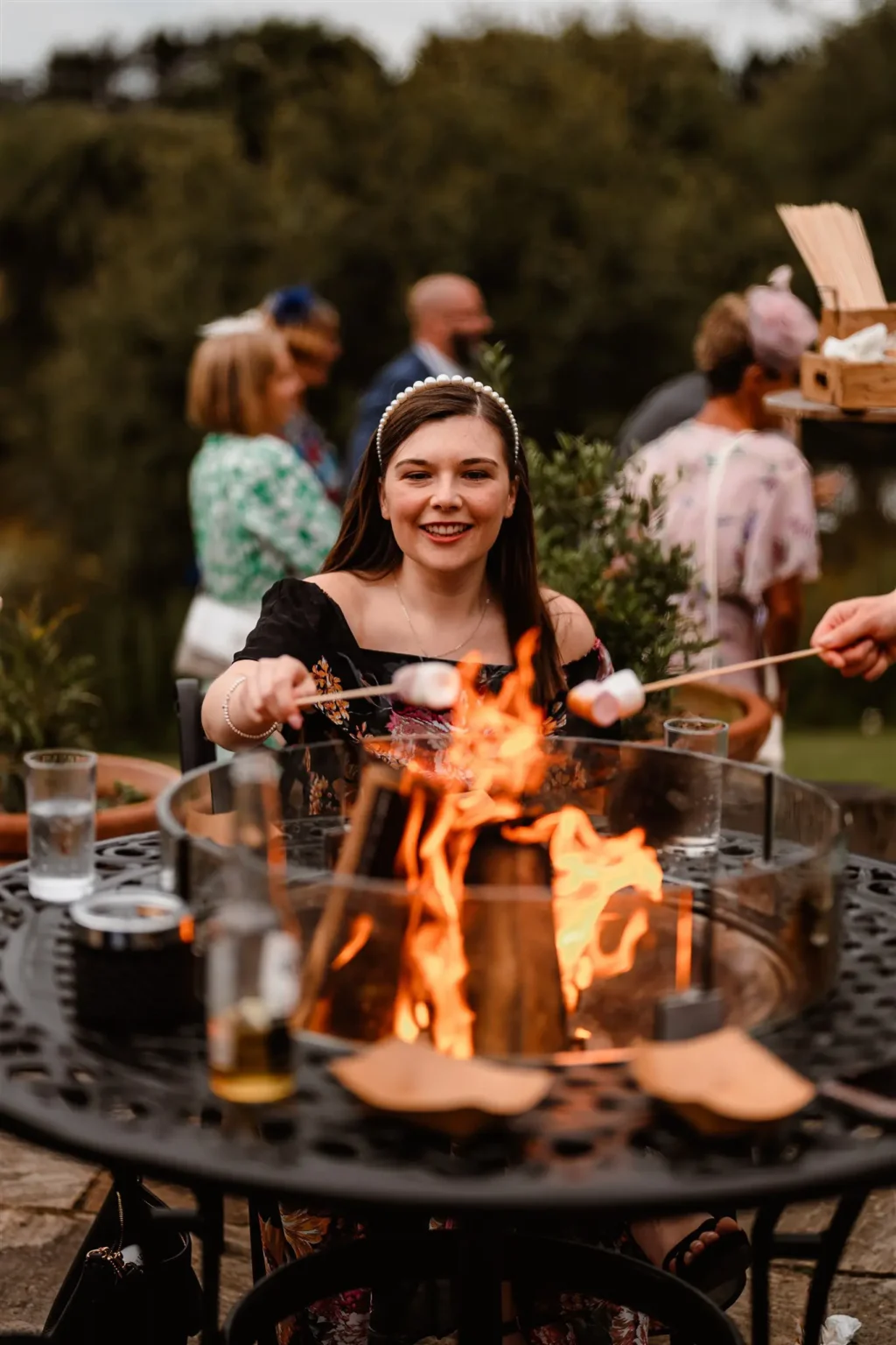 Brookfield Barn toasting marshmallows on fire wedding reception