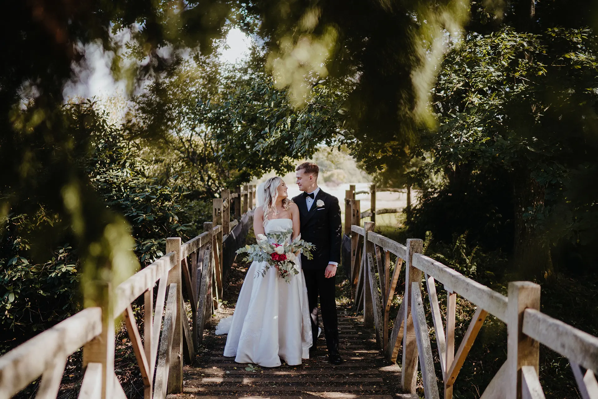Bride and groom on the bridge at Brookfield Barn